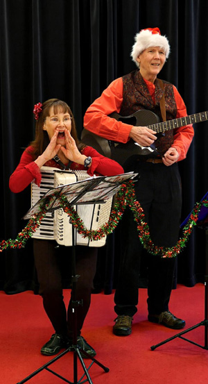 Tom and Mary Kay Aufrance on stage performing Christmas music